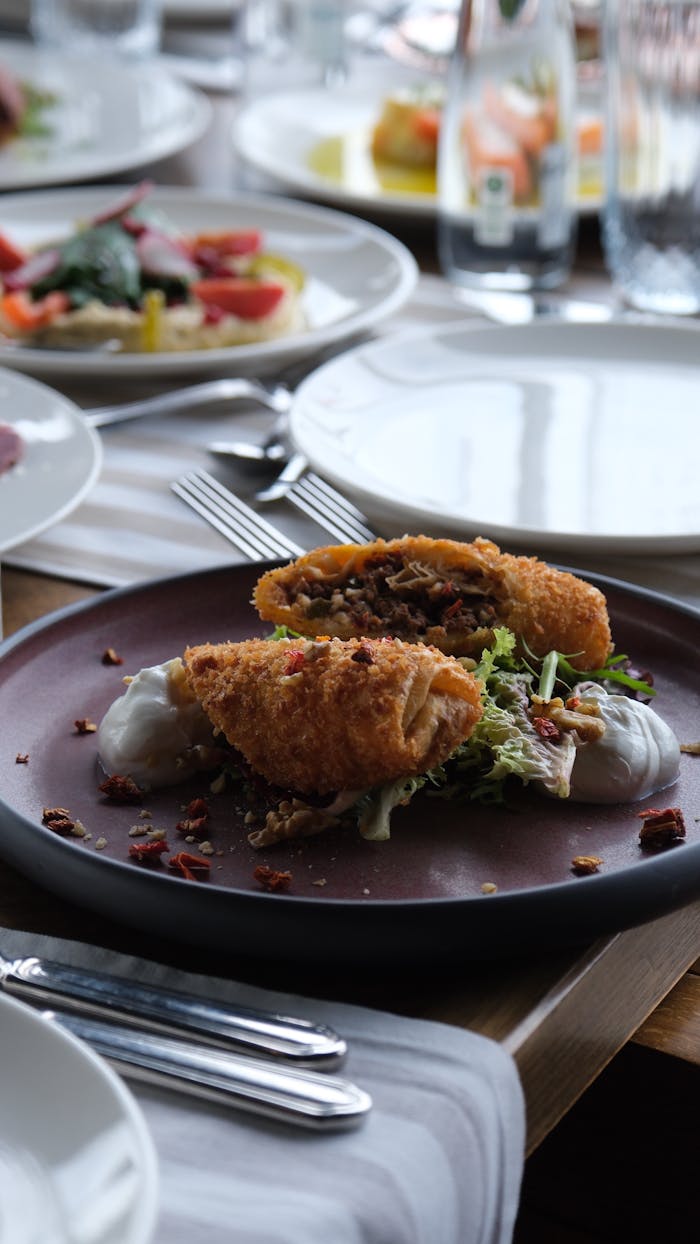 Crispy breaded chicken served on rustic plate with greens.